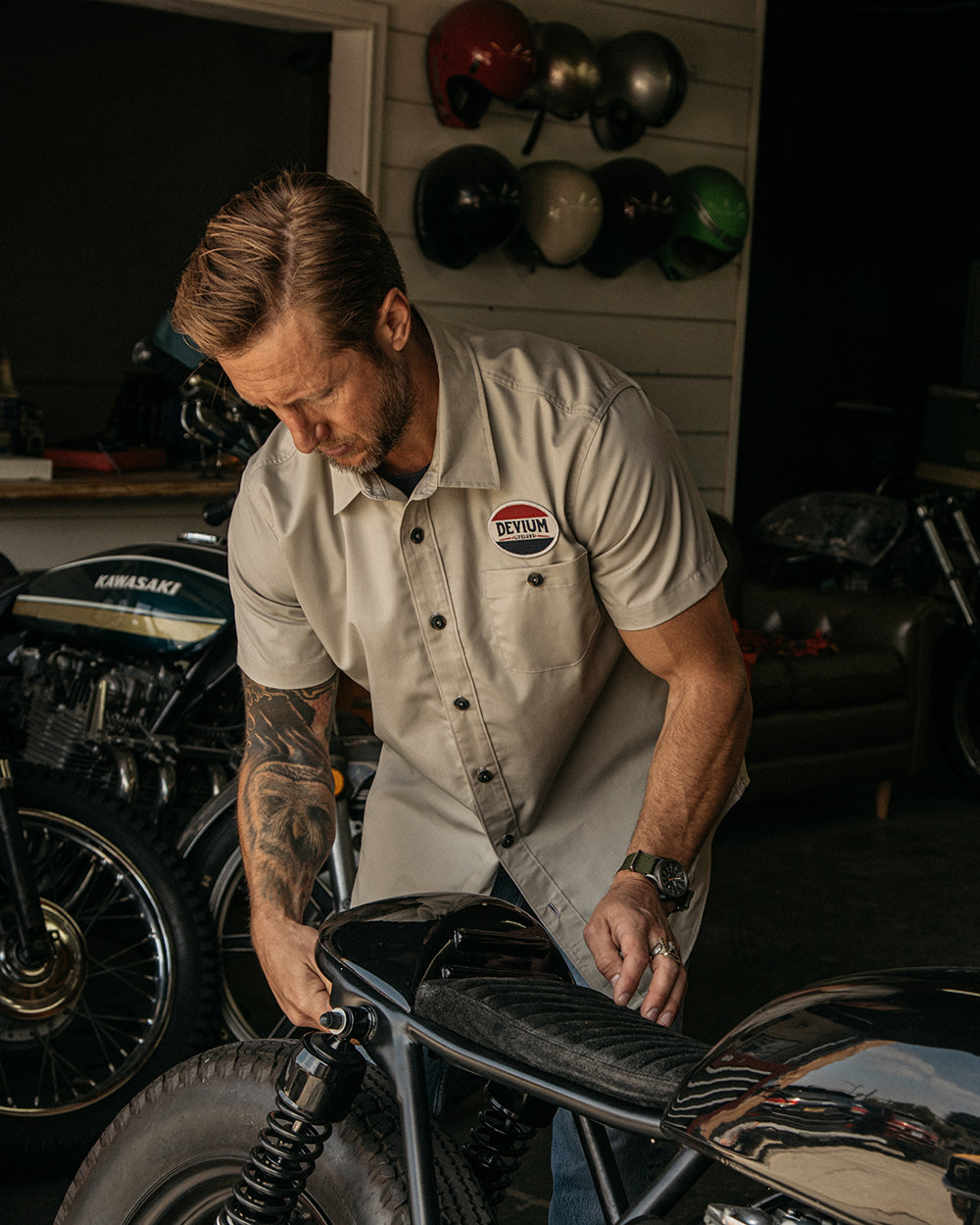 man checking his motorcycle wearing LEROY SHOP SHIRT